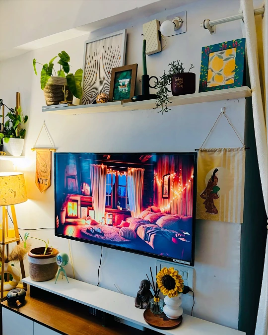 Floating Shelf Gallery Above a Cozy Media Corner