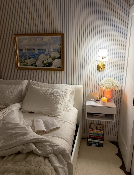 Brass Wall Sconce Beside a Striped Bed Nook