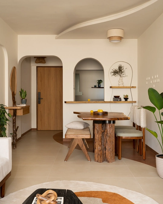 Sculptural Wood Dining Table Beneath Soft Arched Openings