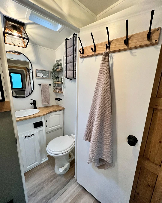 Warm Wood Hooks and White Cabinetry