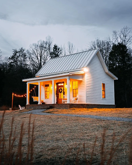 White Farmhouse Cottage with a Porch